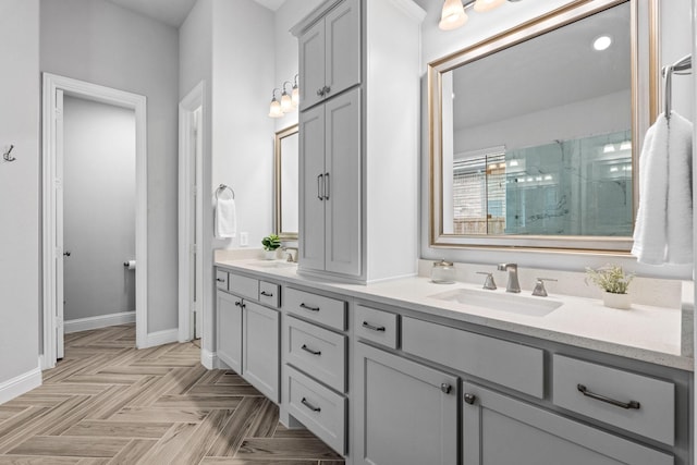 bathroom with vanity, parquet floors, and walk in shower