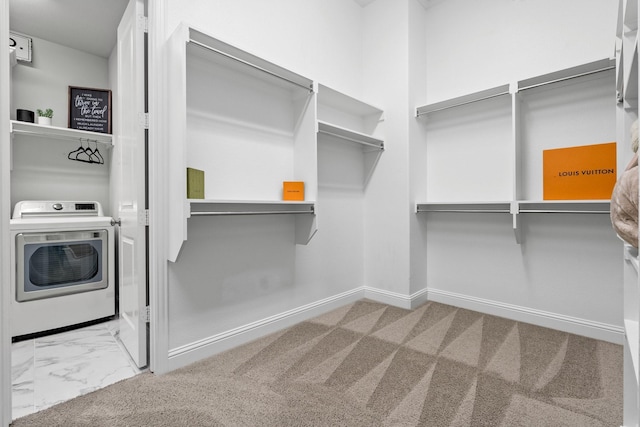 spacious closet featuring washer / clothes dryer and carpet floors