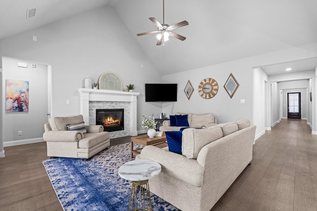 living room with ceiling fan, dark wood-type flooring, and high vaulted ceiling