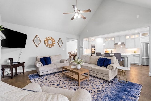 living room featuring sink, high vaulted ceiling, dark hardwood / wood-style floors, and ceiling fan