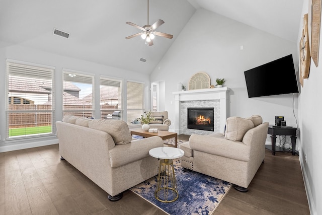 living room featuring ceiling fan, dark hardwood / wood-style floors, and high vaulted ceiling