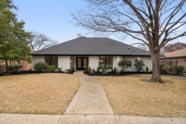 ranch-style house with a front lawn