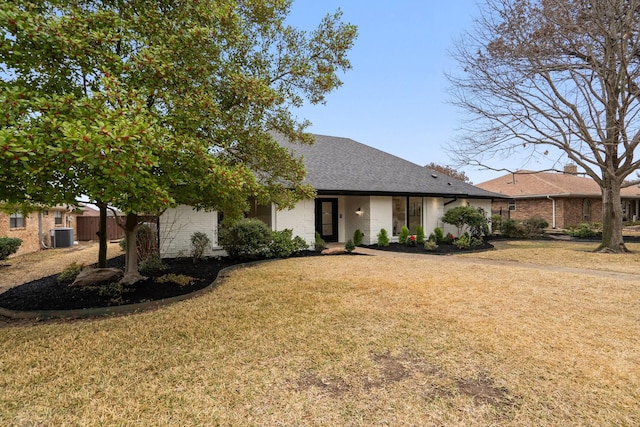 single story home with central AC unit and a front lawn