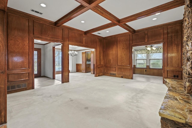 unfurnished living room with coffered ceiling, wooden walls, beam ceiling, and light carpet