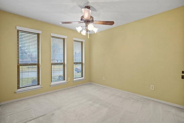 carpeted empty room featuring ceiling fan