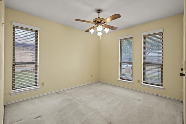 empty room featuring light carpet and ceiling fan