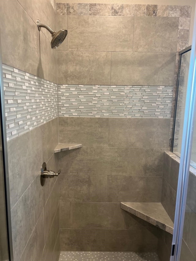 bathroom with tiled shower