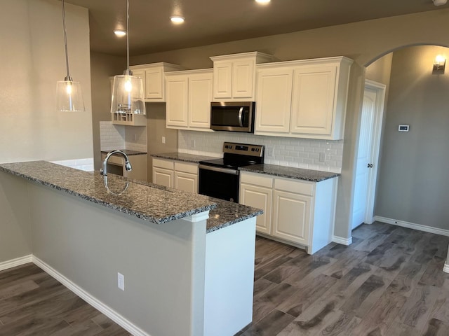 kitchen featuring white cabinetry, appliances with stainless steel finishes, sink, and pendant lighting