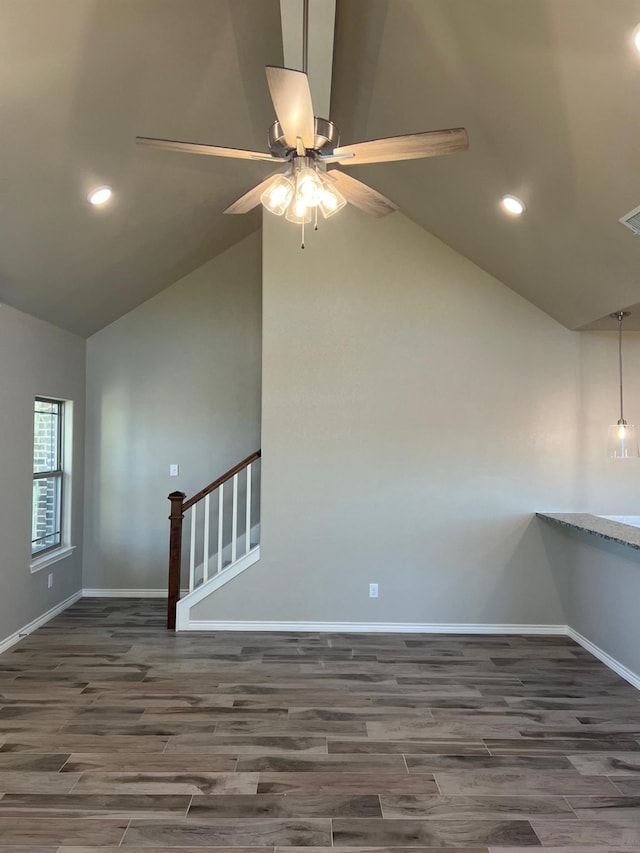 spare room with lofted ceiling, dark wood-type flooring, and ceiling fan