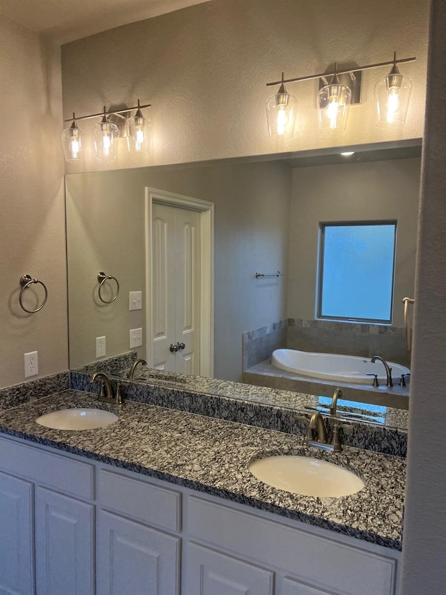 bathroom with vanity and a bathing tub