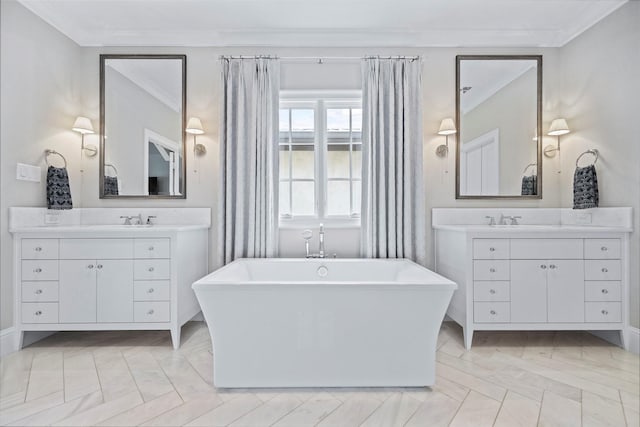 bathroom featuring ornamental molding, a washtub, and vanity