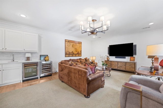 living room featuring crown molding, beverage cooler, and indoor wet bar