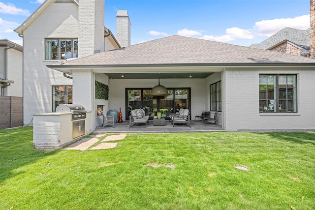 rear view of house featuring area for grilling, an outdoor hangout area, a patio area, and a lawn