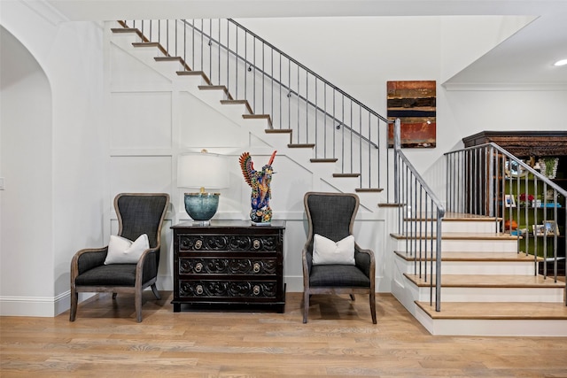 stairway featuring ornamental molding and hardwood / wood-style floors