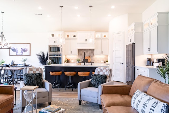 living room with wood-type flooring and a chandelier