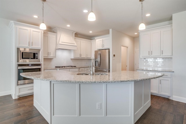 kitchen featuring decorative light fixtures, stainless steel appliances, and white cabinets