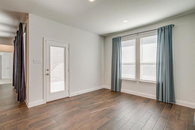 spare room with dark wood-type flooring