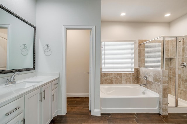 bathroom with shower with separate bathtub and vanity