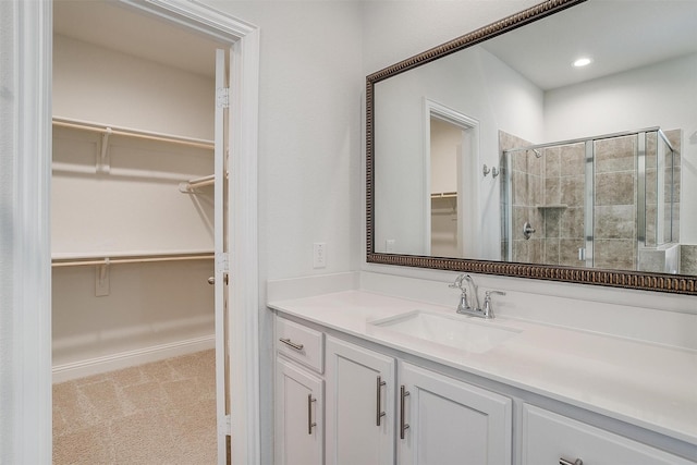 bathroom with vanity and a shower with door