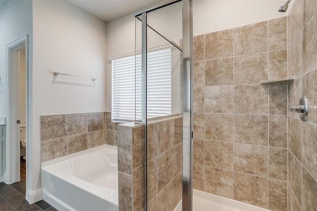 bathroom featuring tile patterned flooring, shower with separate bathtub, and toilet