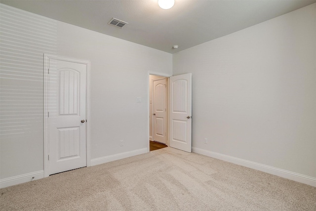 unfurnished bedroom with light colored carpet