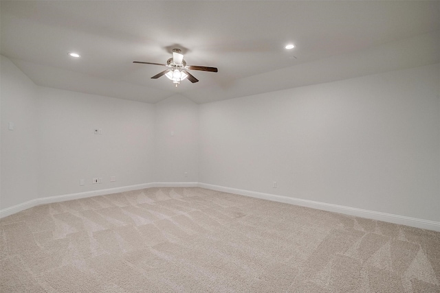 empty room with ceiling fan, lofted ceiling, and carpet floors