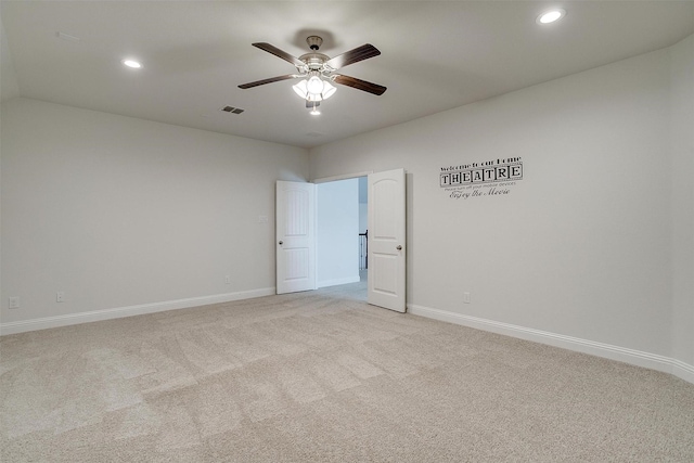 carpeted spare room featuring ceiling fan