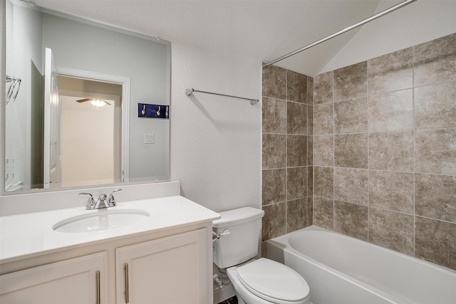 full bathroom featuring vanity, toilet, tiled shower / bath combo, and vaulted ceiling