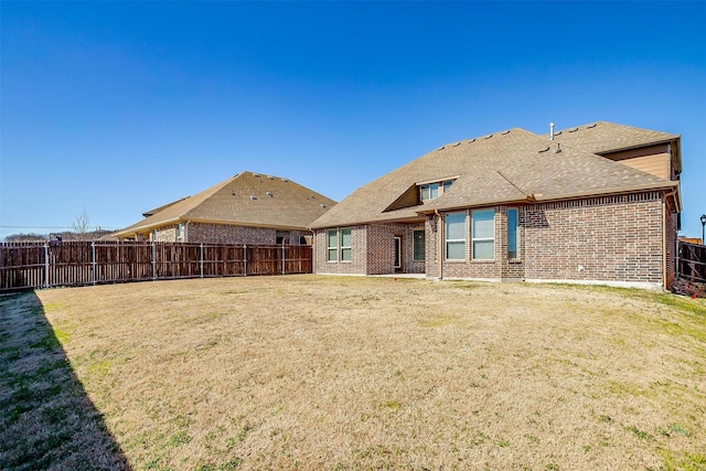 rear view of house with a yard