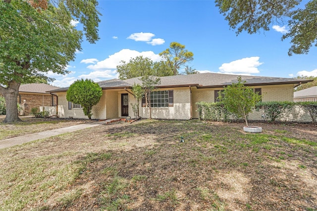 ranch-style house with a front lawn and brick siding