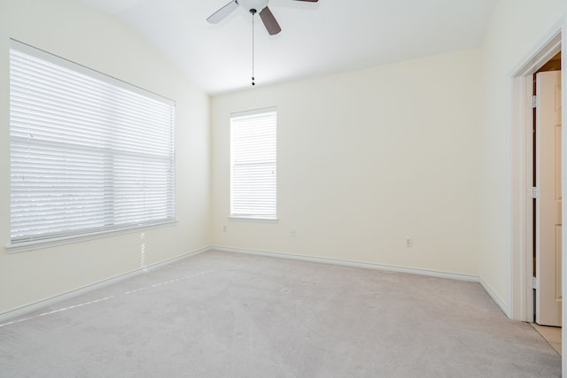 empty room with lofted ceiling, light carpet, and ceiling fan