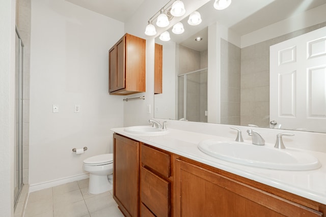 bathroom featuring tile patterned floors, toilet, a shower with door, and vanity