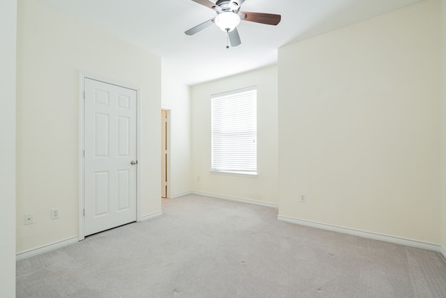 carpeted empty room featuring ceiling fan