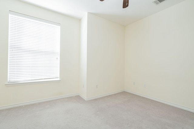 carpeted spare room with ceiling fan