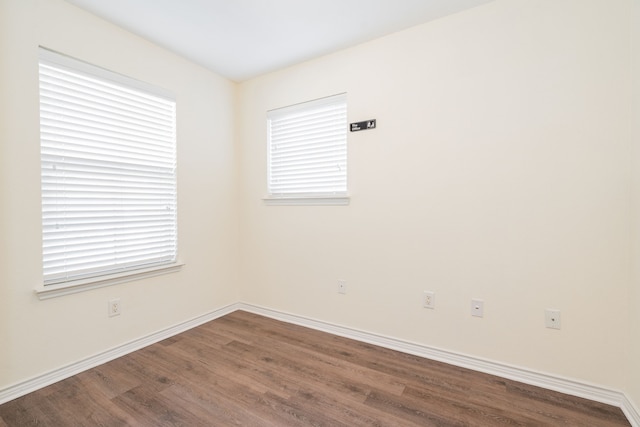 unfurnished room featuring hardwood / wood-style flooring