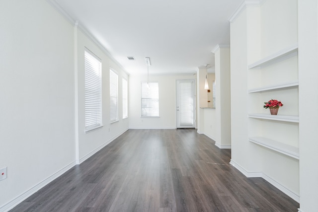 interior space with built in shelves, dark hardwood / wood-style flooring, and crown molding