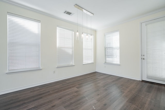 spare room with ornamental molding and dark hardwood / wood-style floors