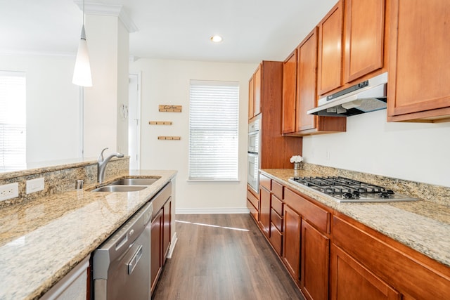 kitchen featuring sink, appliances with stainless steel finishes, light stone counters, dark hardwood / wood-style flooring, and decorative light fixtures