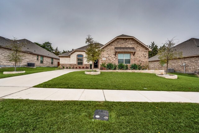 french country inspired facade featuring a garage and a front yard