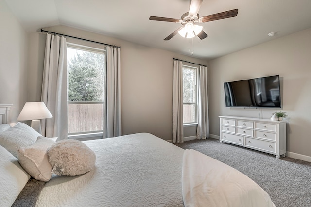 carpeted bedroom with lofted ceiling, baseboards, and ceiling fan