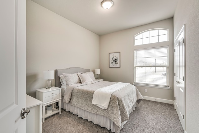 bedroom with light carpet and baseboards