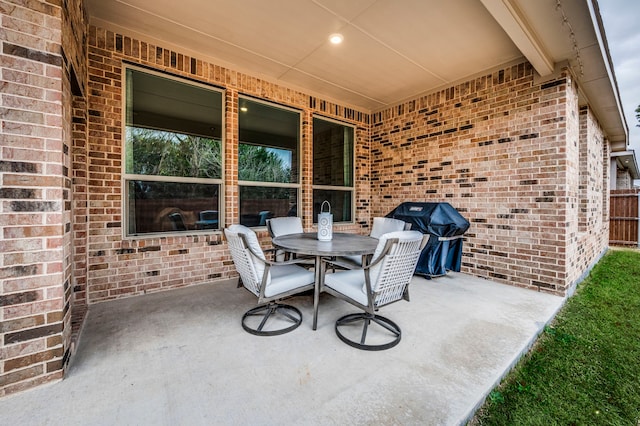 view of patio with a grill and outdoor dining area