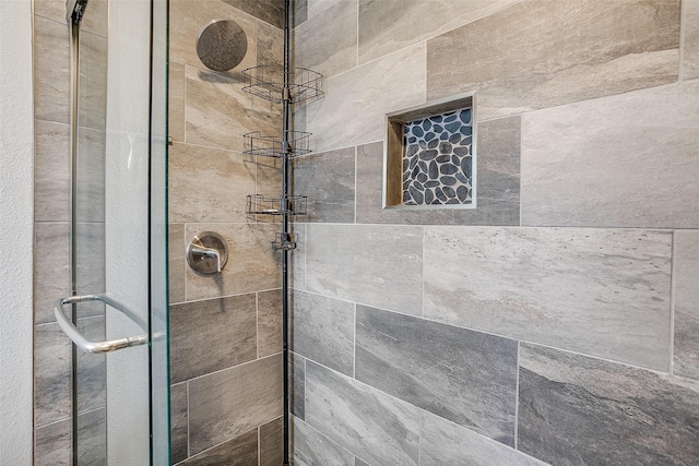 bathroom featuring a shower with door