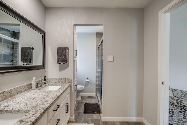 bathroom with vanity, wood-type flooring, walk in shower, and toilet