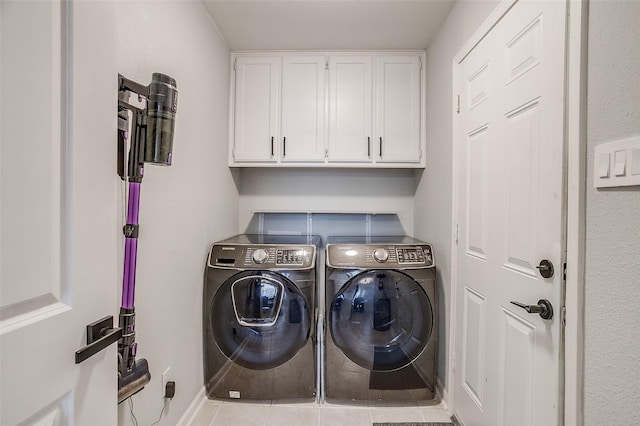 washroom featuring cabinets, independent washer and dryer, and light tile patterned flooring