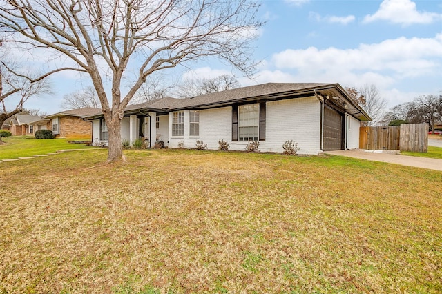 ranch-style home with a garage and a front lawn