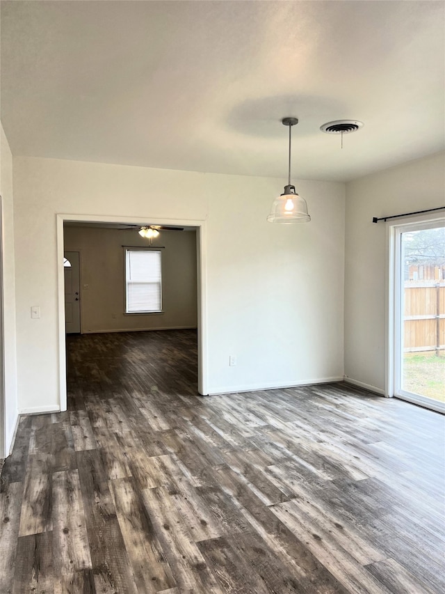 unfurnished room with dark hardwood / wood-style flooring