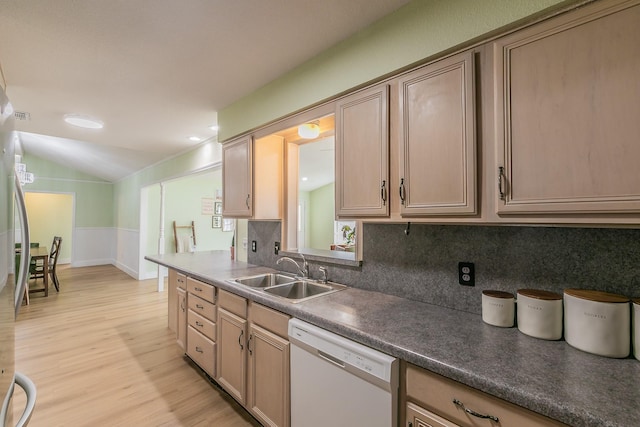 kitchen featuring lofted ceiling, white dishwasher, sink, and light brown cabinets