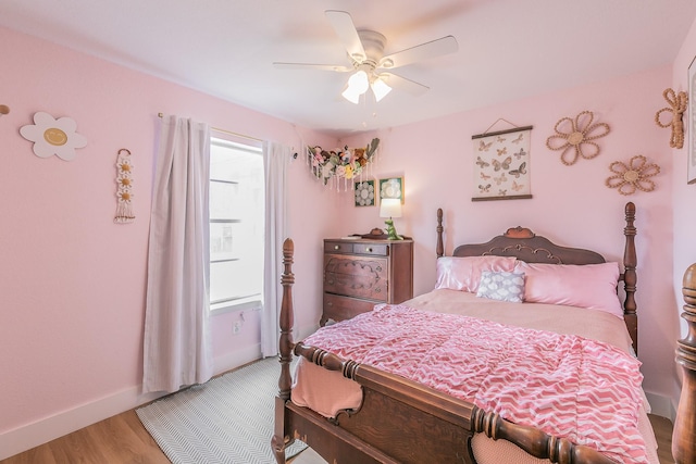 bedroom with hardwood / wood-style flooring and ceiling fan