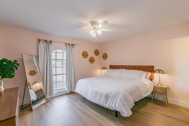 bedroom with ceiling fan and wood-type flooring